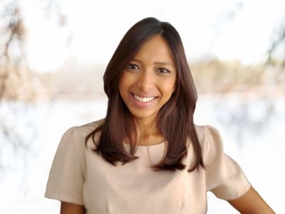 Portrait of a smiling woman with long hair.