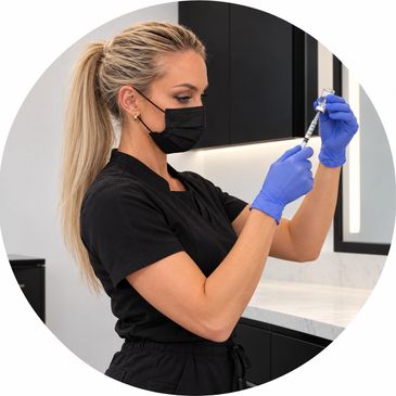 Nurse preparing a vaccine syringe.