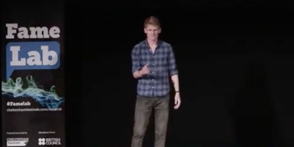 Person presenting at FameLab event on stage.