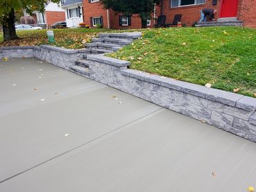 Paver wall and stairs. Concrete parking pad