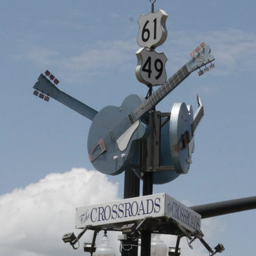 The Crossroads sign with guitars and highway signs.