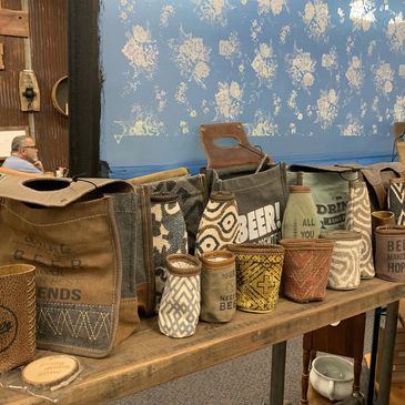 Rustic bags and patterned cups on a wooden table.