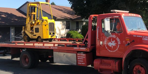 One of our Fleet Trucks towing a Forklift.