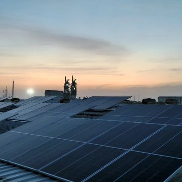 Solar panels absorbing sunlight during a sunset.