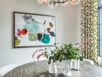 Formal dining with colorful art drapery and sculpted table scape