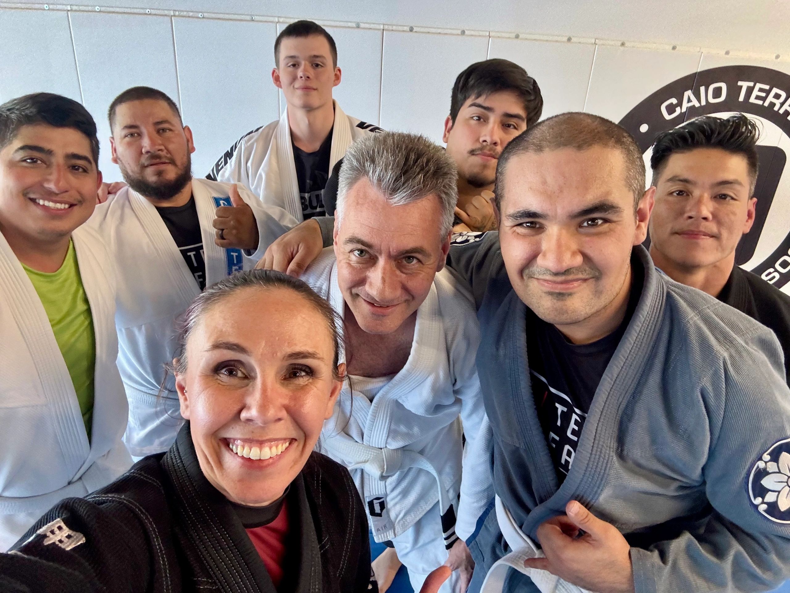 Group of friends smiling after training jiu jitsu