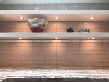 Kitchen shelves with decorative items and warm lighting.