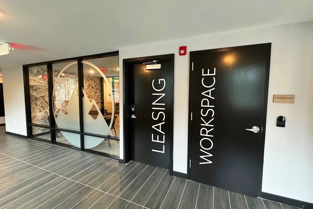 Window graphics applied to an office space window and vinyl letters applied to an entry door.