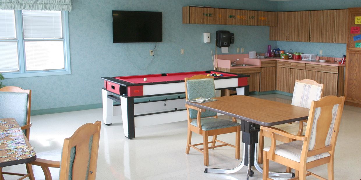 Pine View Manor Activities Room with pool table, kitchen area, and jigsaw puzzle table