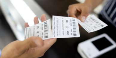 Hands exchanging luggage tags.