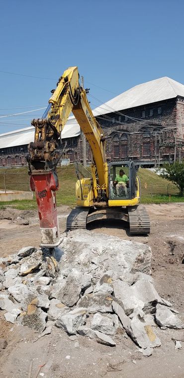 Burton Excavating, Inc - 49783 site prep, water/sewer/septic system, landscape materials. Hammer