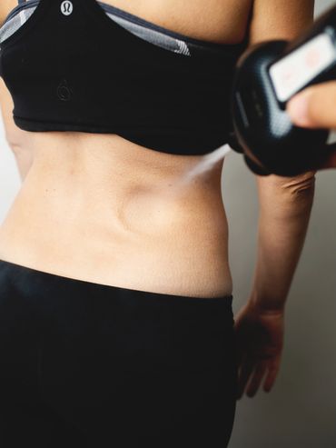 Woman's torso receiving a body treatment.