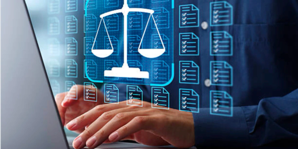 Legal professional working on a laptop with scales of justice and document symbols.