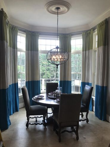 Dining area with bold draperies, interior designer