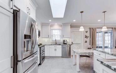 Renovated kitchen with a light airy feel, and stainless steel appliances