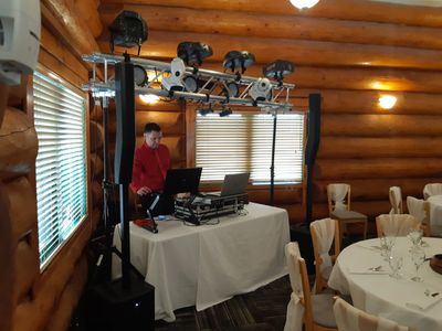 Dale with his small DJ booth, mixing equipment,speakers  and lights at a wedding.  
