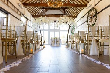 wedding ceremony styling with ivory chair drapes & gold lanterns and blossom trees