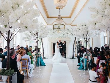 Wedding ceremony styling with blossom trees and aisle runner at Northbrook Park in Farnham