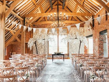 Wedding ceremony styling with scatter petals and blossom trees