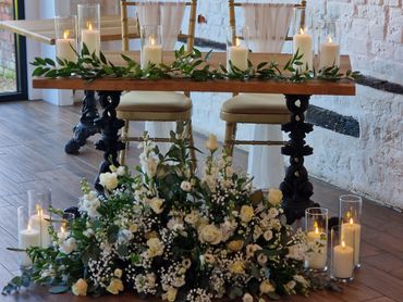 Elegant wedding table styling with floral arrangements & candles at Lillibrooke Manor in Maidenhead