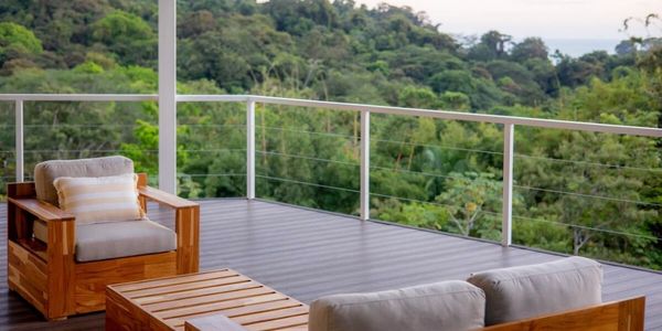 Outdoor lounge deck with jungle and ocean view at a Manuel Antonio Costa Rica yoga teacher training