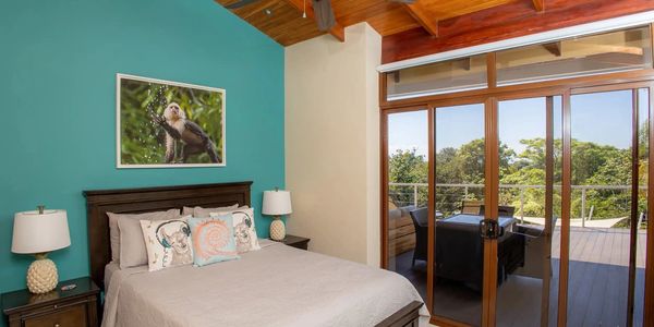 Queen bed with jungle view balcony at an affordable 200 hour YTT in Manuel Antonio Quepos Costa Rica