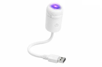 Small USB device with a glowing blue light.
