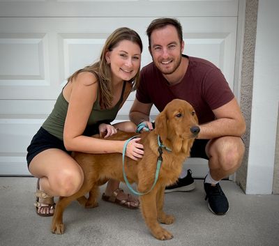 A couple taking care of the dog