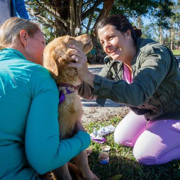 A two girls taking care of the dog