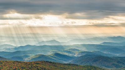 A view of mountains and rays of light from the sky