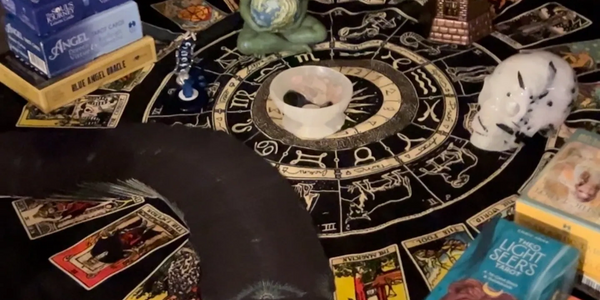 Online Tarot reading surrounding by Crystal Scull and card decks