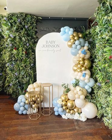 Elegant baby shower setup with balloons and greenery for Baby Johnson.