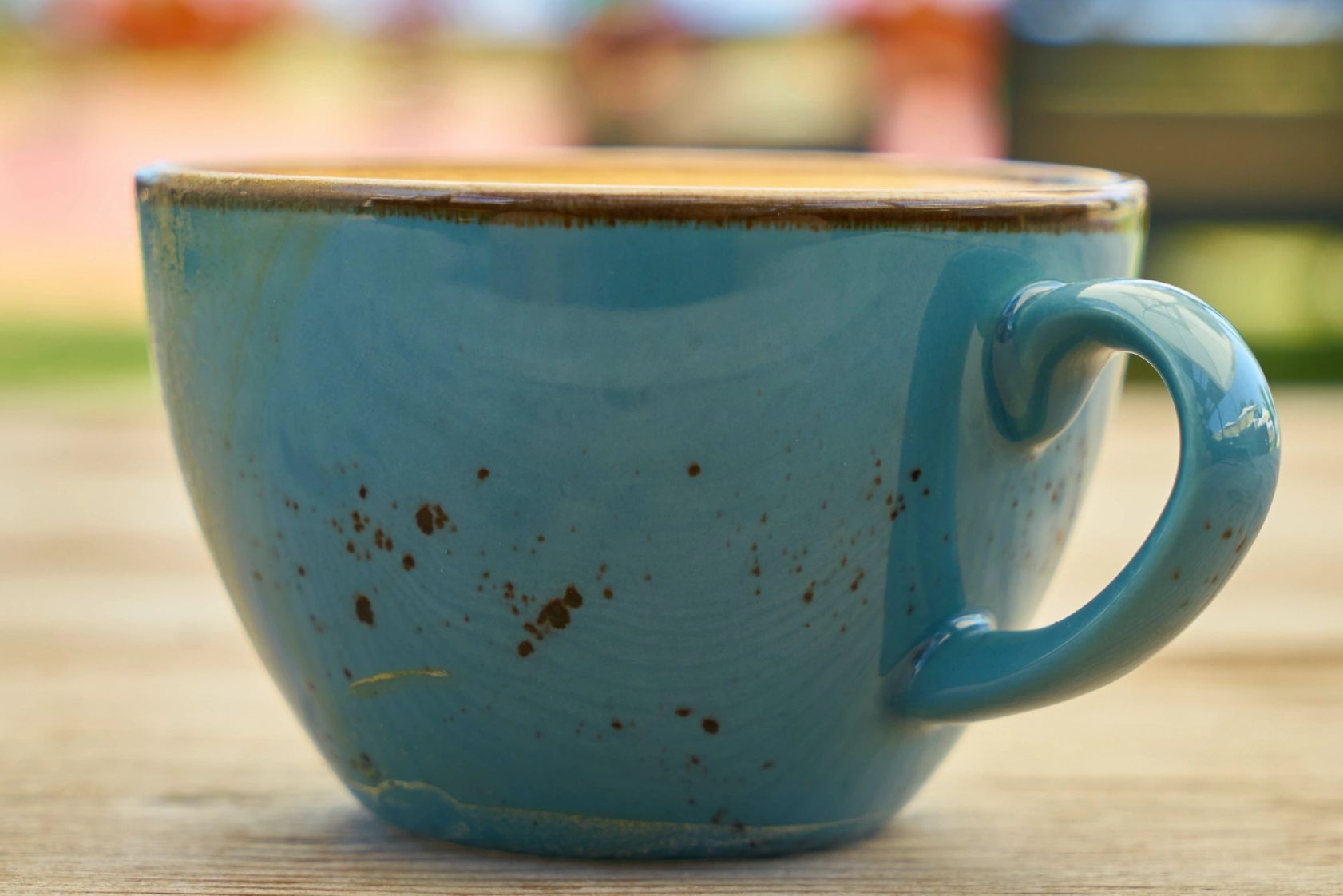 A blue cup on a table representing the Mental Health & Wellbeing page. Azure Dragonfly Counselling