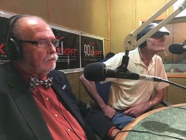 Two elderly men broadcasting in a radio studio.