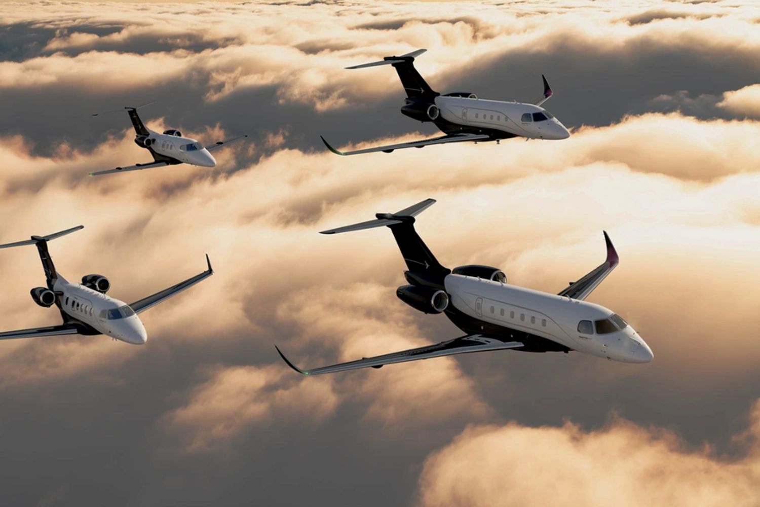Embraer business jets flying over layer of clouds at dusk sun light over the horizon.