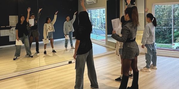 Group performance class at X-Talent focusing on singing, movement and stage skills.
