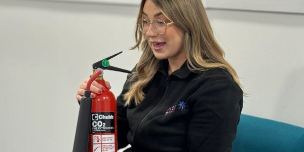 Woman holding a CO2 fire extinguisher.