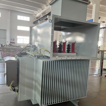 Large industrial transformer inside a spacious factory.