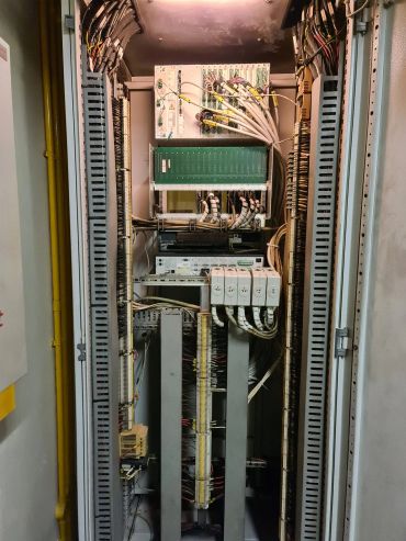 Inside view of a complex electrical control panel with organized wiring and components.