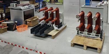 Electrical components on pallets in an industrial setting.
