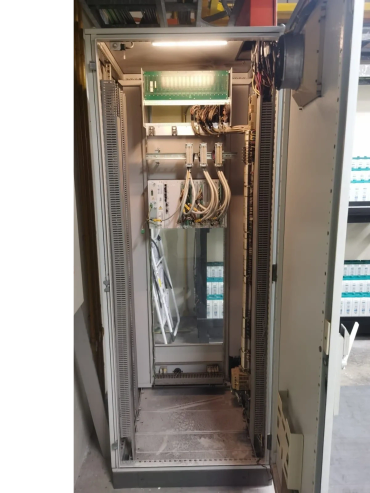 Open industrial electrical control panel with wiring and components.