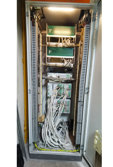 Open electrical control panel with organized wiring and circuit boards.