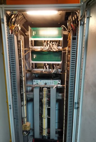Open electrical control panel with organized wiring and circuit boards.