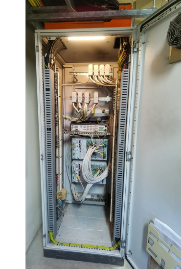 Open electrical control panel with organized wiring and circuit components.