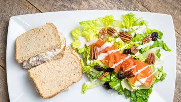 Chicken salad sandwich with a side of walnut salad.