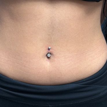 Naval piercing with silver gemstone jewelry
