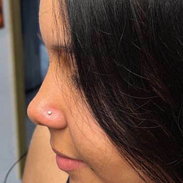 Nostril piercing with silver gemstone stud