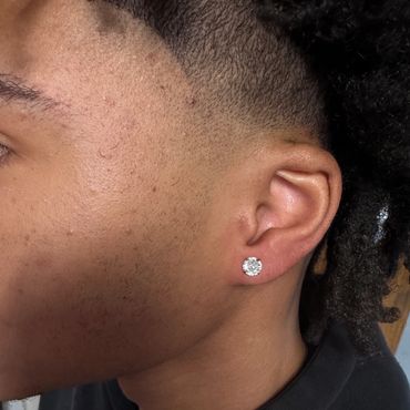 Ear lobe piercing with round gemstone stud