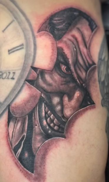 Black and grey Joker character tattoo