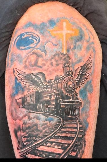 Winged steam train with a colorful sky memorial tattoo